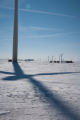 Round hay bales and wind turbines in winter on Buffalo Ridge, Pipestone County, Minnesota.