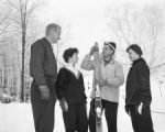 A group of four people gathered on Rock Hill in winter