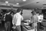 People cutting a large cake at the 30th anniversary celebration of Kirby Student Center