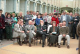Speakers at the UMD Campus Center dedication ceremony seated in front of standing guests