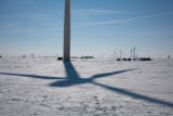 Round hay bales and wind turbines in winter on Buffalo Ridge, Pipestone County, Minnesota.