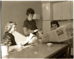 Students drinking coffee and reading the newspaper in dorms