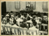 Mr. S.C. Li, program secretary of the Nanking Association, presides at a worship service.