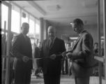 Three people cutting the ribbon at the opening of the Social Science Building at UMD