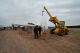 A crane assembling the windmill at UMD Farm